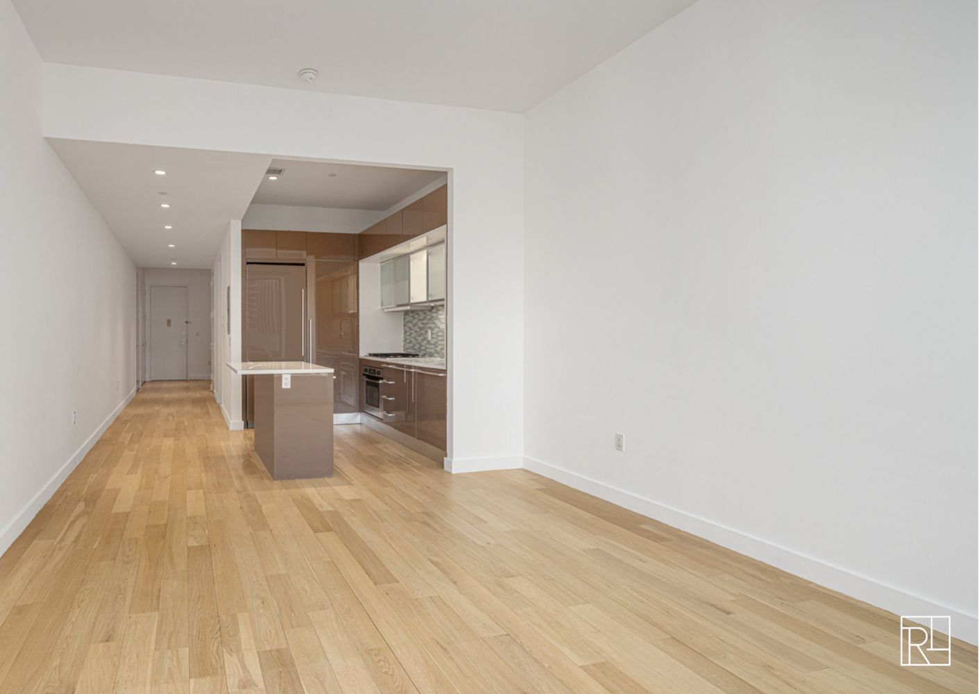 75 Wall Street, Unit 28D Manhattan, NY 10005 - Photo 15 of 35 a view of a kitchen with wooden floor