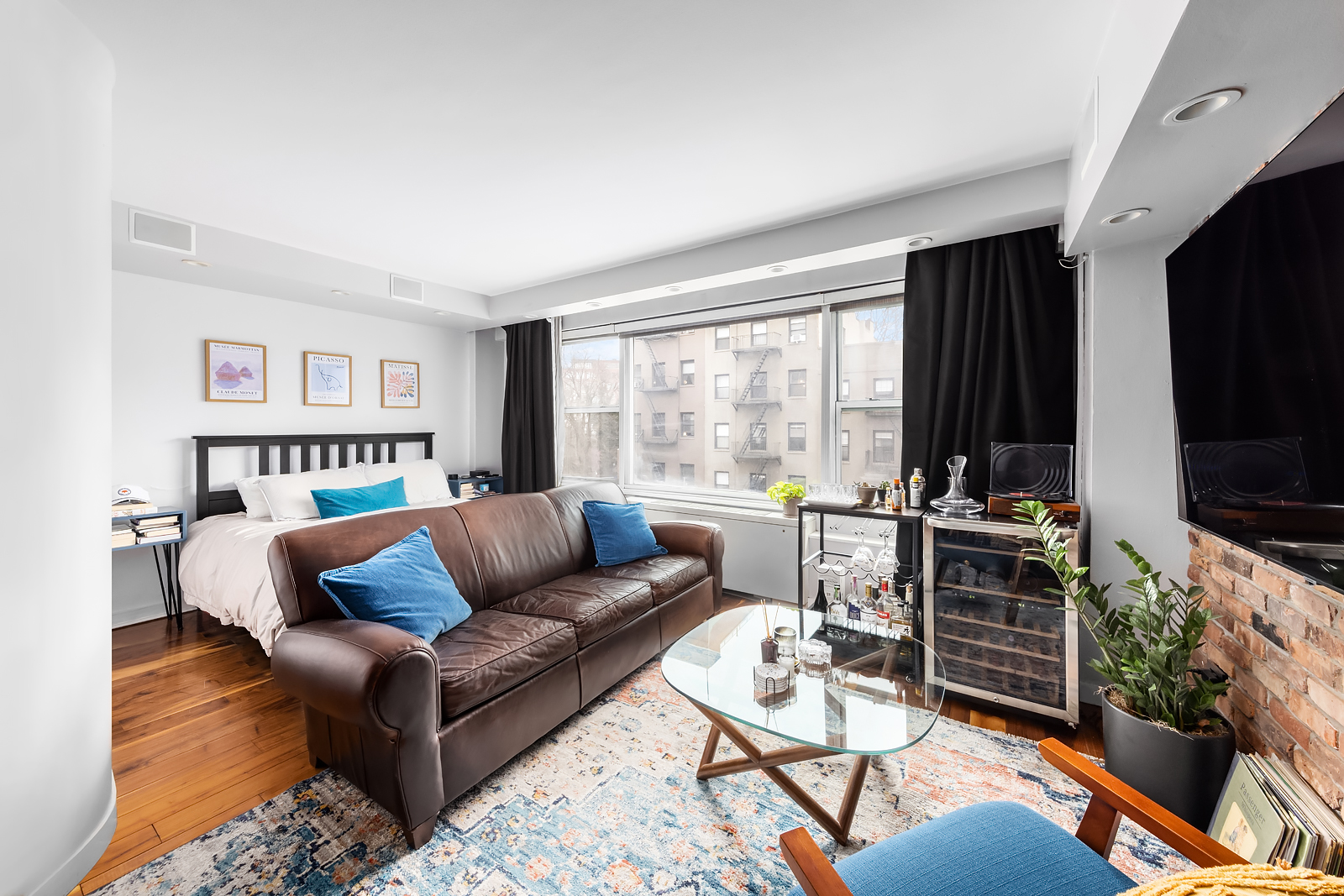 33 Greenwich Avenue, Unit 4E Manhattan, NY 10014 - Photo 4 of 10 a living room with furniture and a flat screen tv