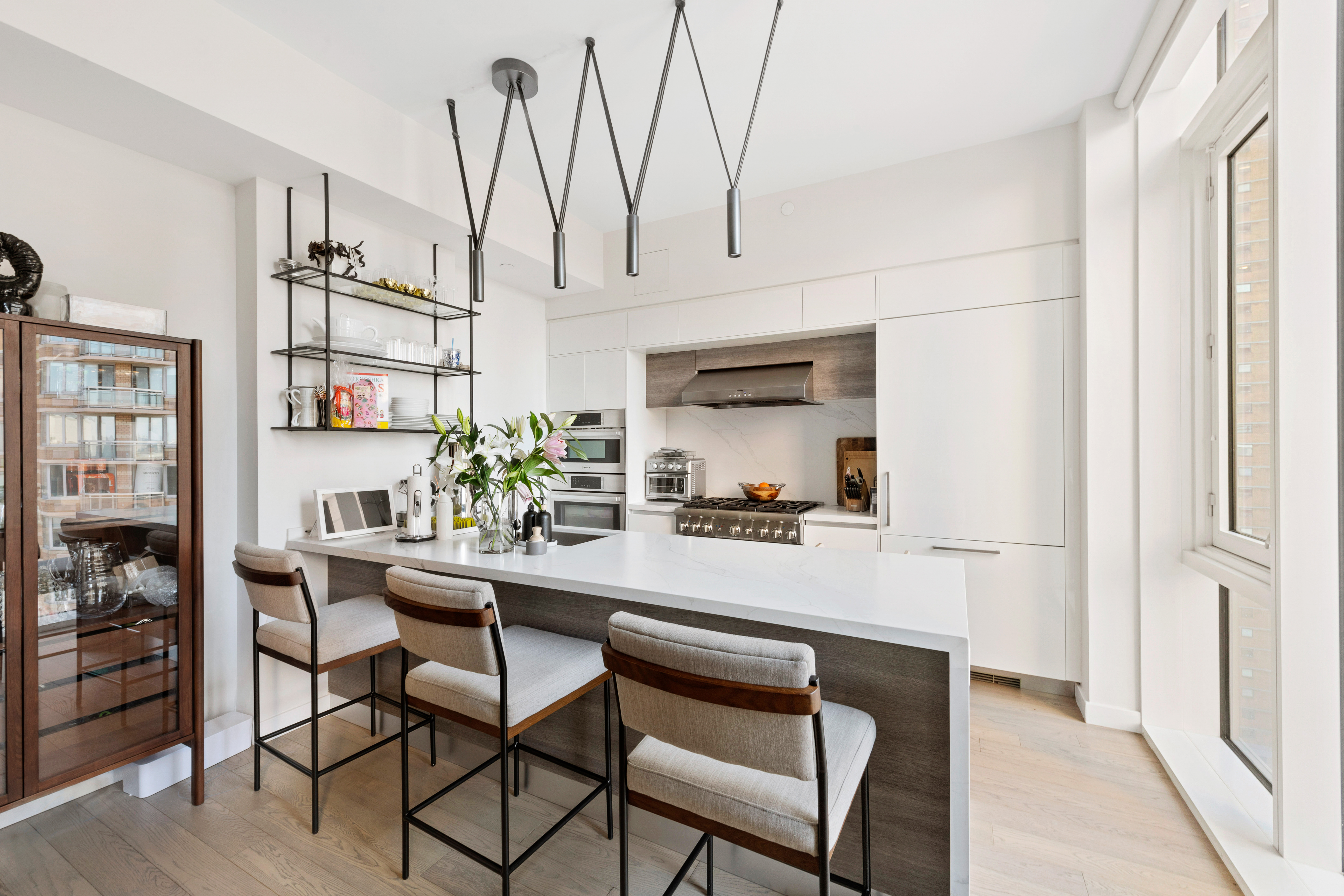 505-513 West 43rd Street, Unit PHG Manhattan, NY 10036 - Photo 5 of 20 a dining room with furniture and window