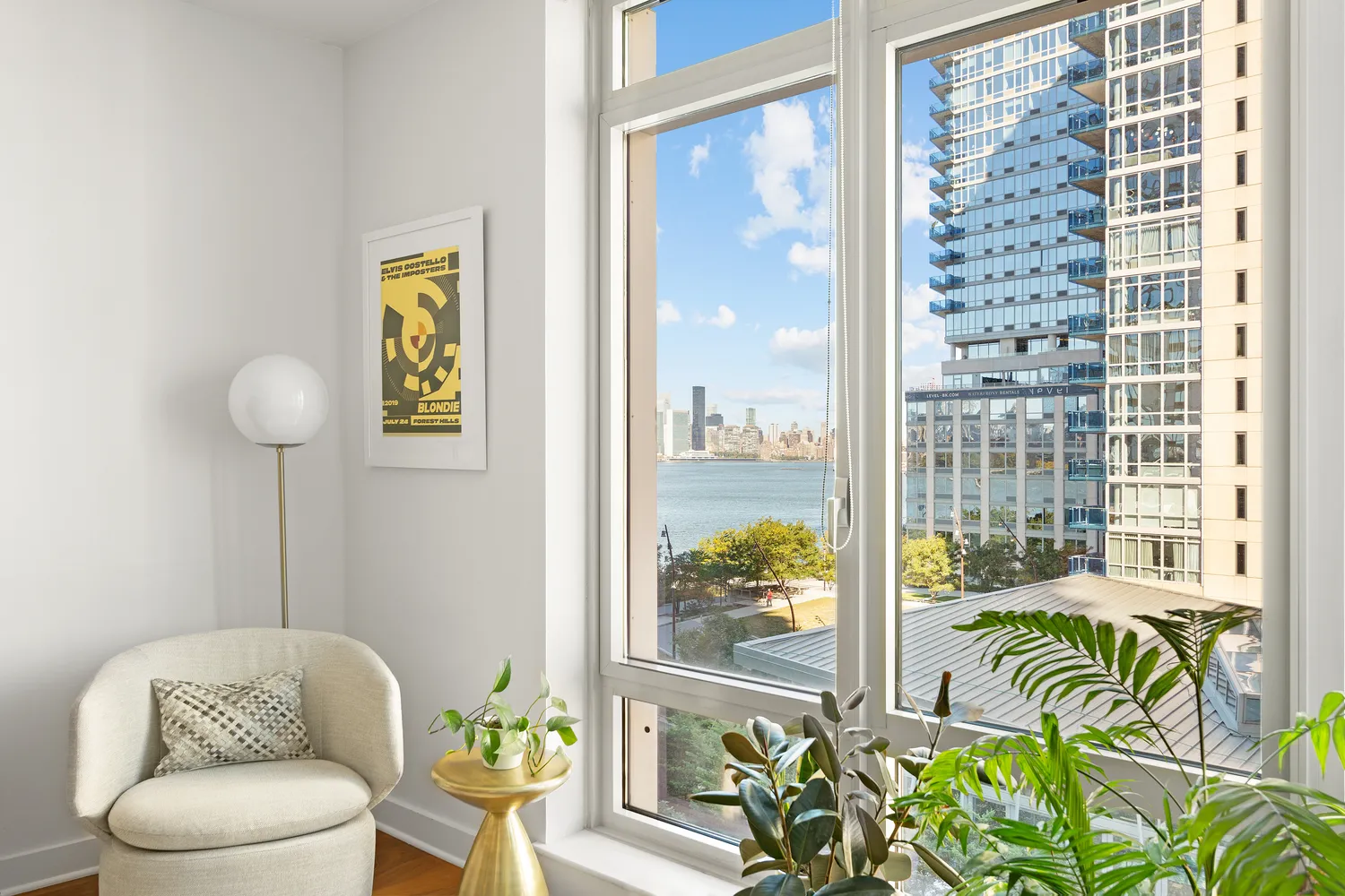 a living room with furniture and a floor to ceiling window