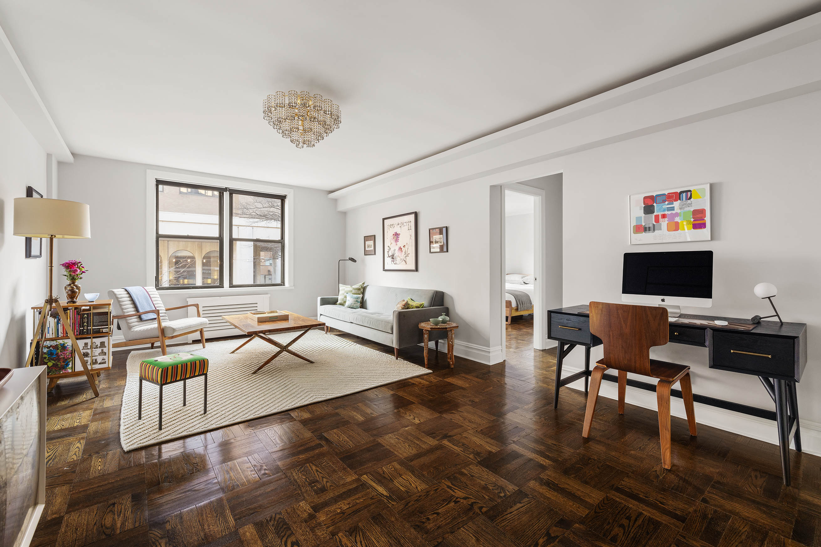 60 East 9th Street, Unit 211 Manhattan, NY 10003 - Photo 1 of 7 a living room with fireplace furniture and a flat screen tv