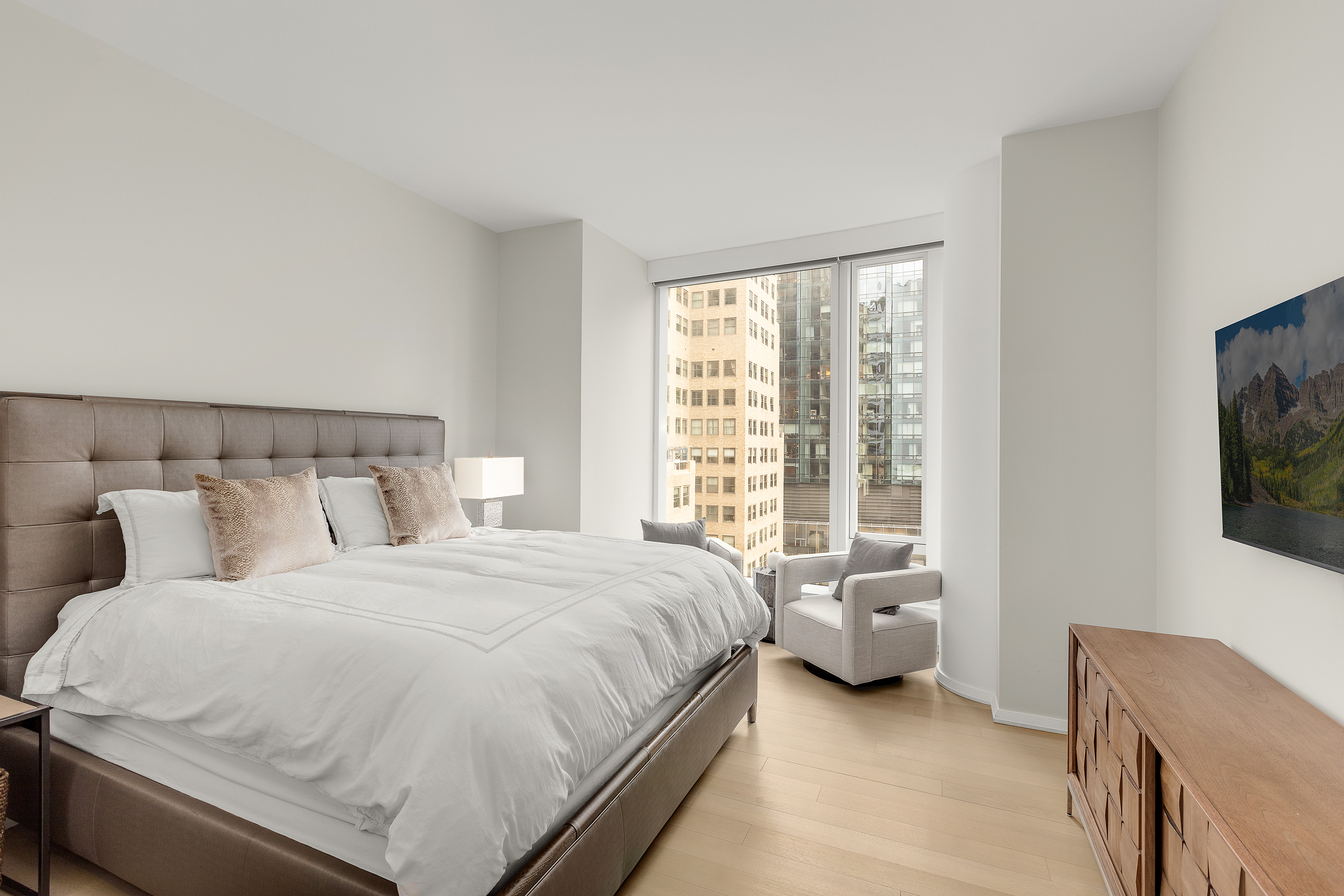 50 West Street, Unit 14B Manhattan, NY 10006 - Photo 7 of 29 a bedroom with a bed and a couch