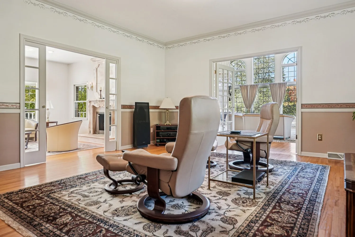 a living room with furniture a rug and a table