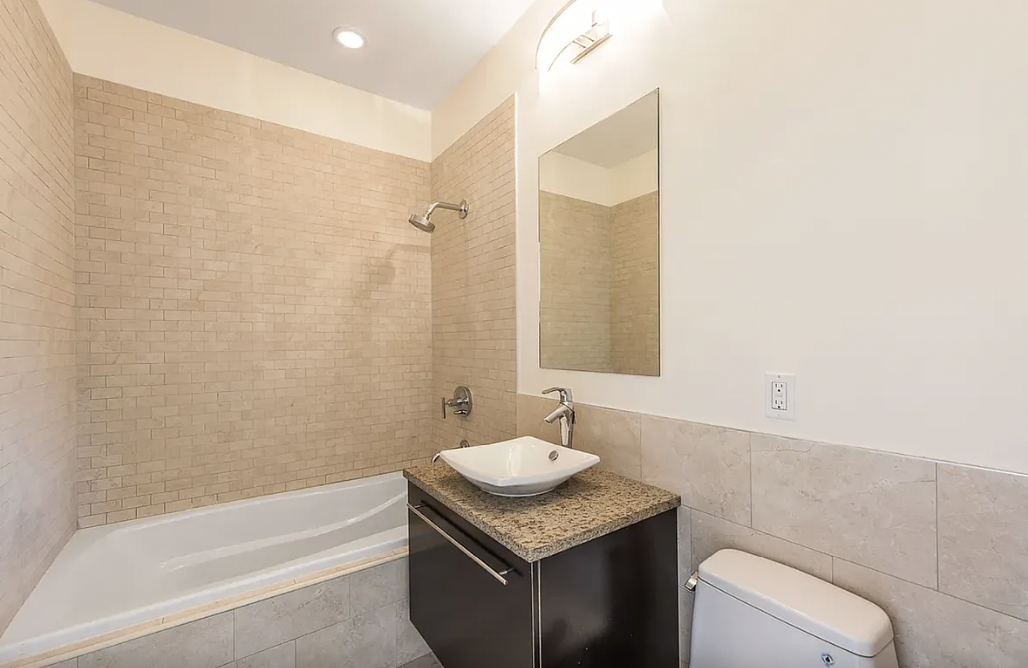 42-37 27th Street, Unit 8C Queens, NY 11101 - Photo 4 of 11 a bathroom with a granite countertop sink and a mirror