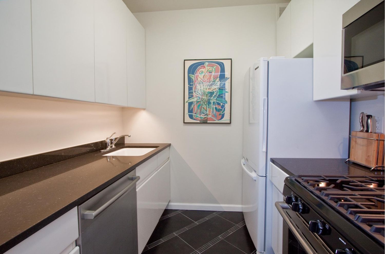 222 Riverside Drive, Unit PH2E Manhattan, NY 10025 - Photo 12 of 18 a kitchen with a stove and a refrigerator