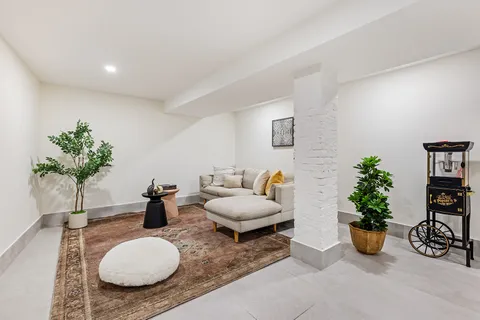 a living room with furniture potted plant and a window