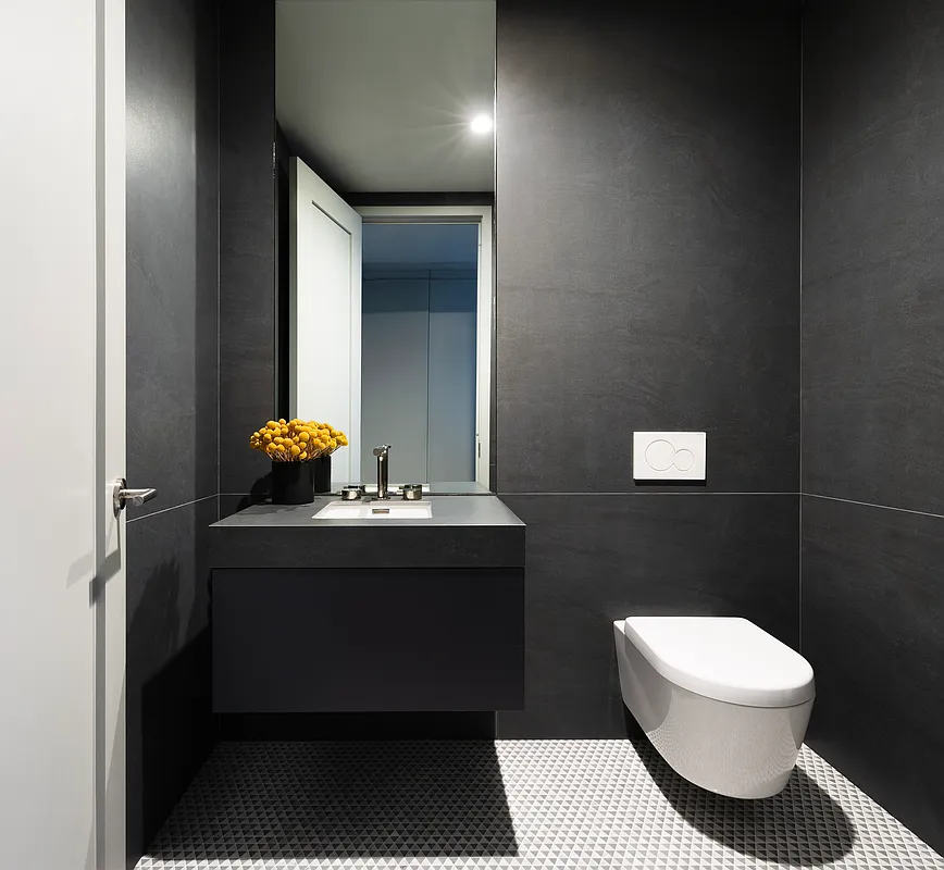 1059 3rd Avenue, Unit 25 Manhattan, NY 10065 - Photo 12 of 13 a bathroom with a sink a toilet and a mirror