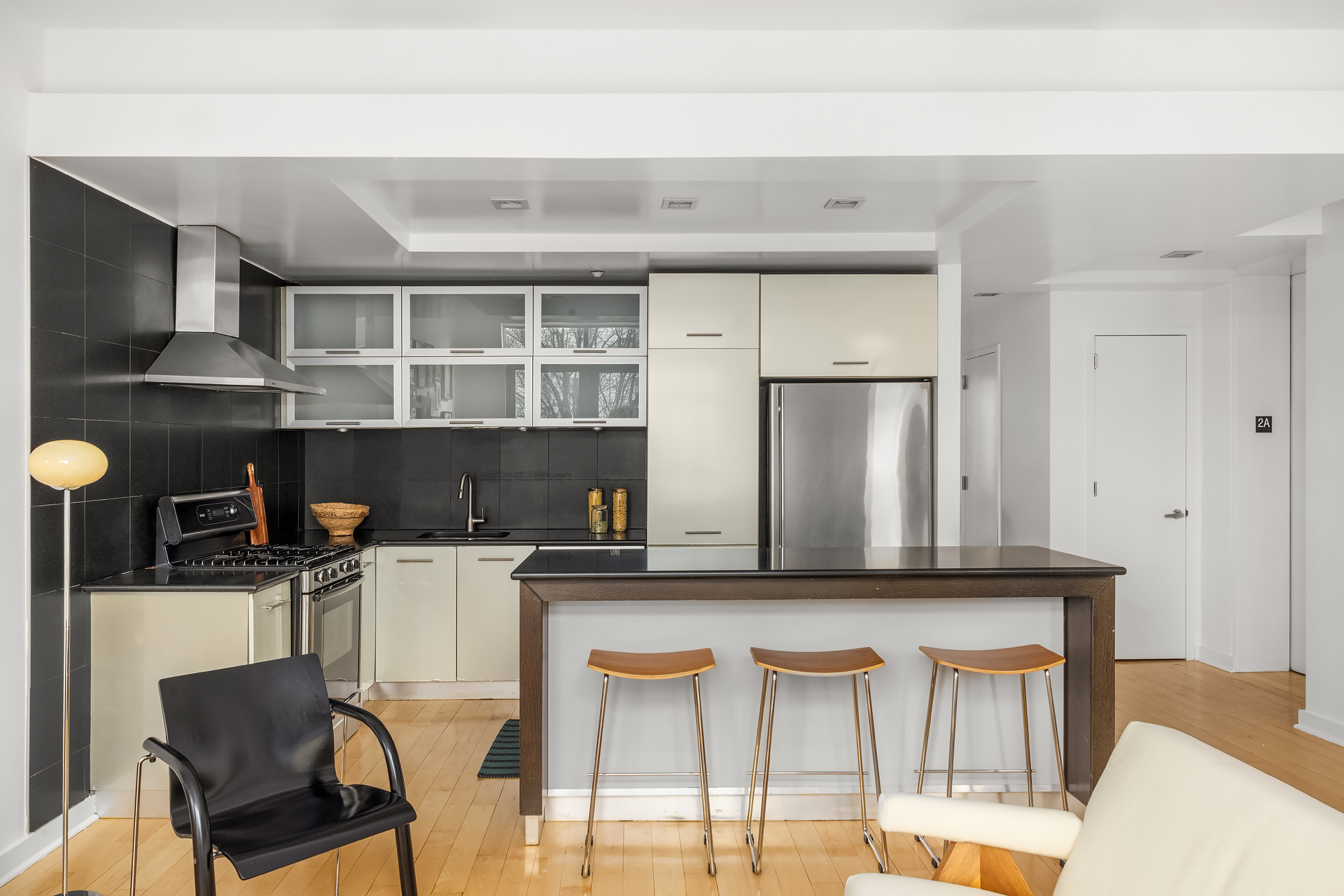 82 Guernsey Street, Unit 2A Brooklyn, NY 11222 - Photo 7 of 16 a kitchen with a table chairs and a refrigerator