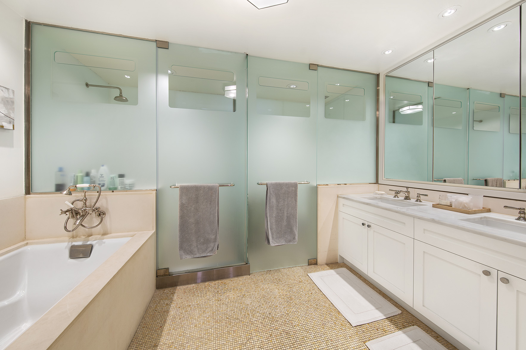92 Laight Street, Unit 5I Manhattan, NY 10013 - Photo 6 of 12 a spacious bathroom with a tub sink and mirror