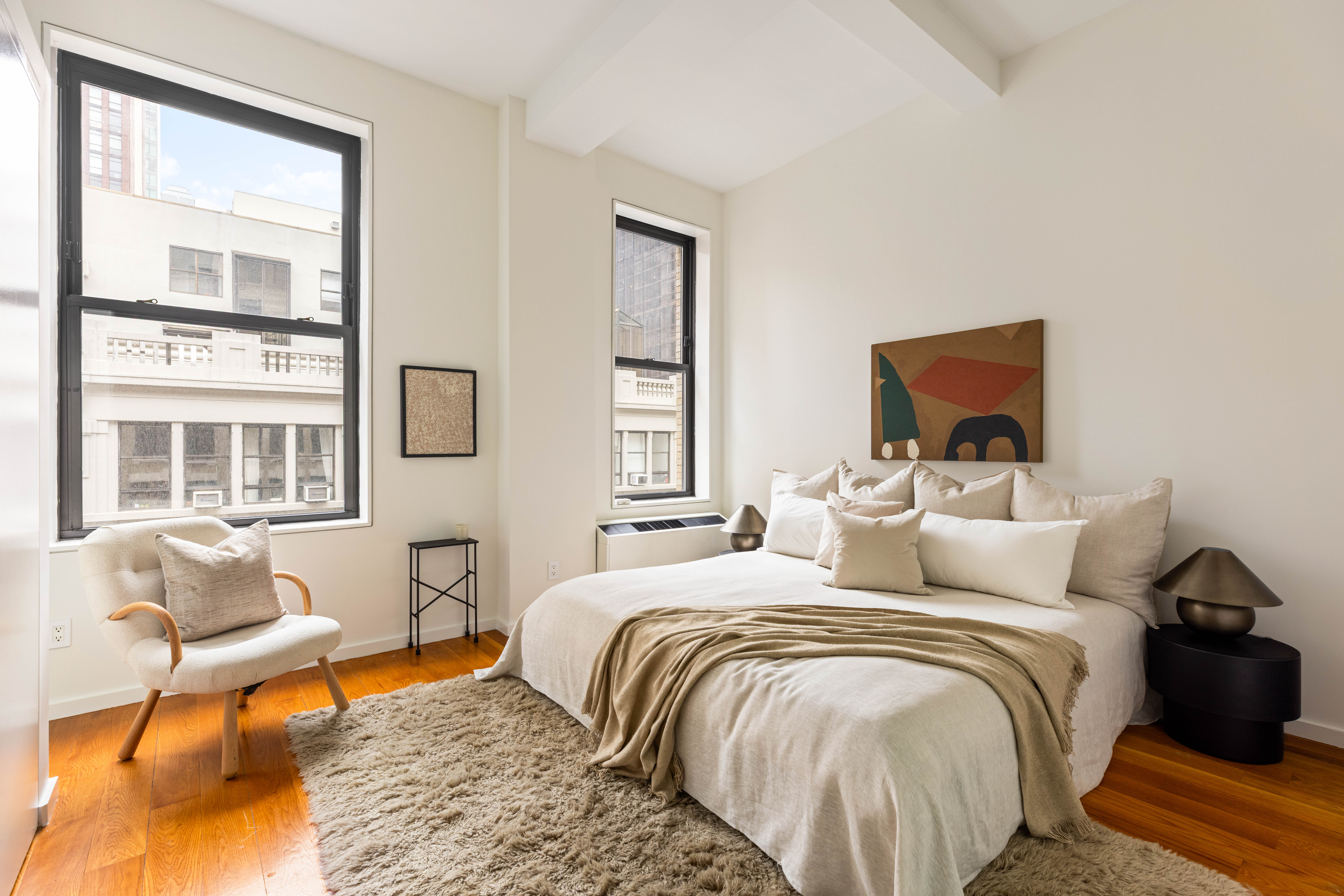 76 Madison Avenue, Unit 8C Manhattan, NY 10016 - Photo 6 of 9 a bedroom with a bed and wooden floor