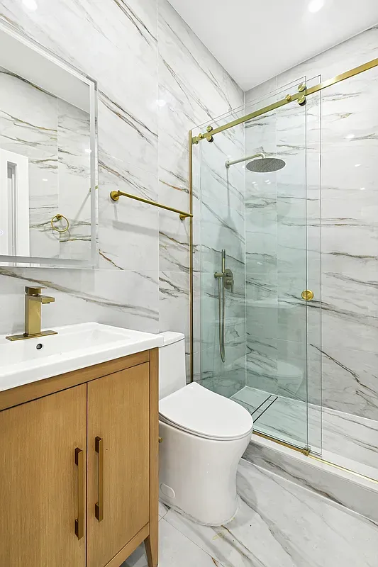 a bathroom with a shower toilet and sink