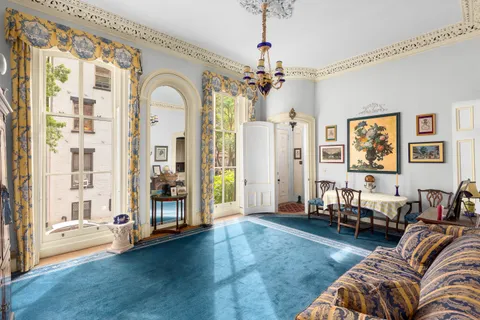 a living room with furniture and a chandelier