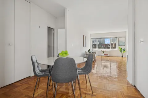 a dining room with furniture and window