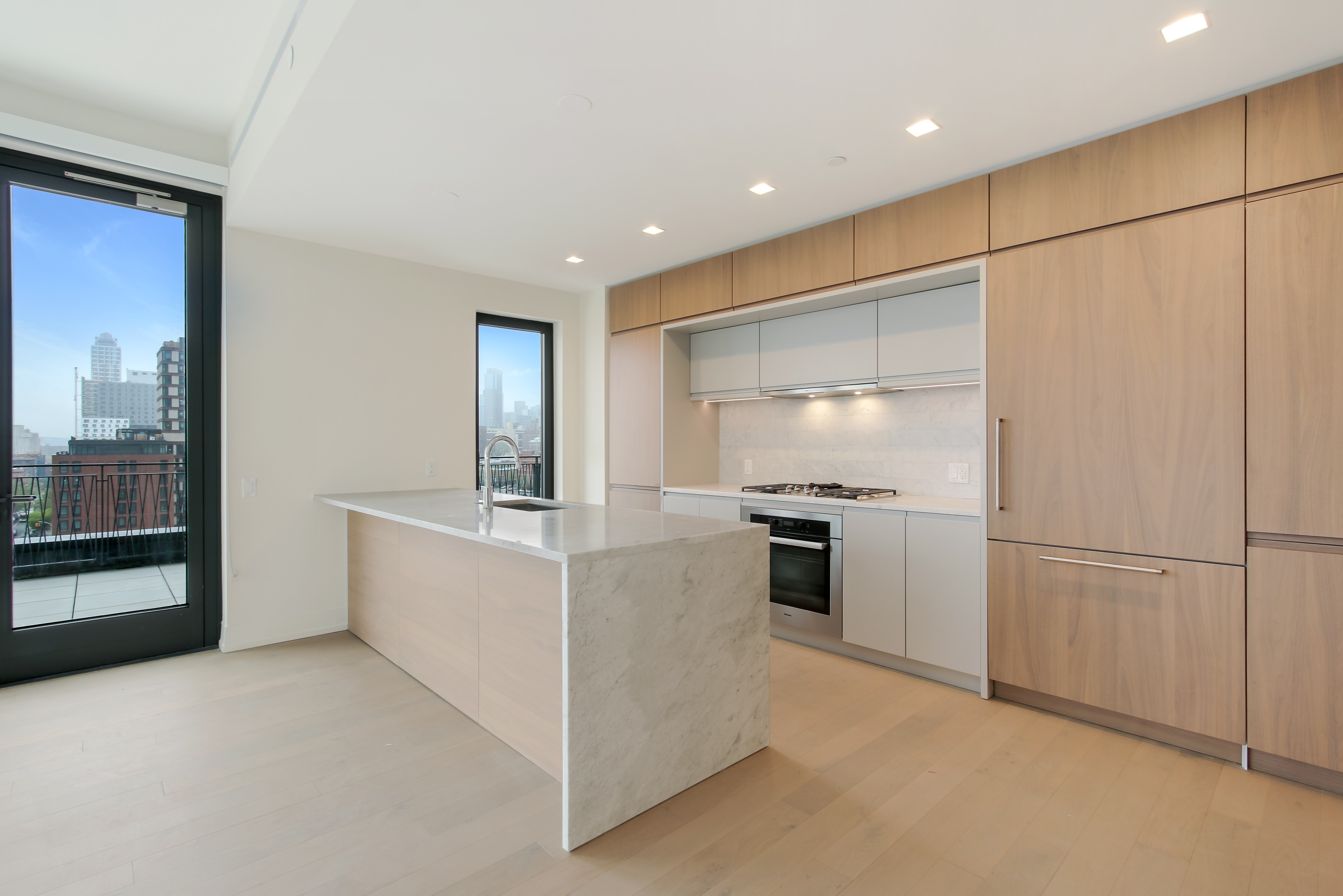 550 Vanderbilt Avenue, Unit 630 Brooklyn, NY 11238 - Photo 2 of 10 a kitchen with white cabinets and stainless steel appliances