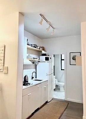 205 West 103rd Street, Unit 1C Manhattan, NY 10025 - Photo 2 of 5 a view of a bathroom with sink dryer and washer