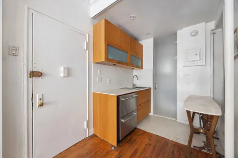 a kitchen with stainless steel appliances granite countertop a sink and a refrigerator