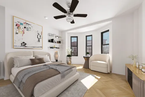 a bedroom with a large bed couch and a window