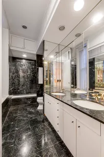 a large white kitchen with a large window
