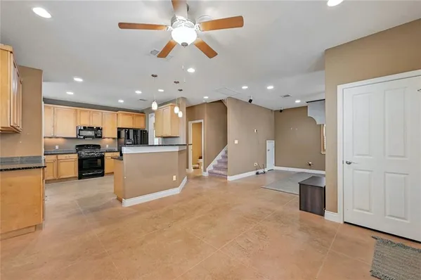 a view of a kitchen with a sink and a refrigerator