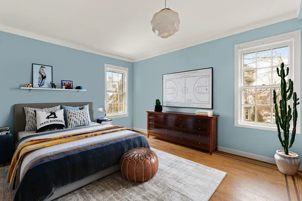 a bedroom with a bed and wooden floor