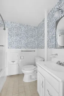 a bathroom with a sink a toilet and a mirror
