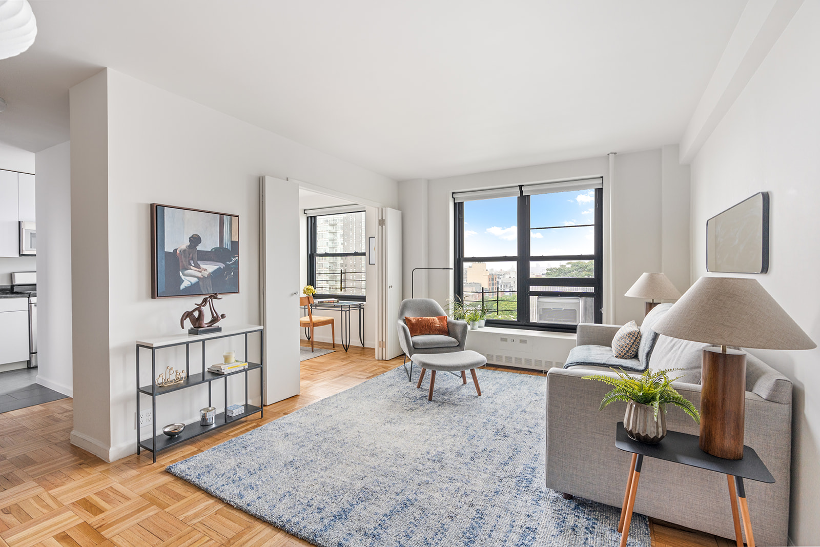 a living room with furniture and wooden floor