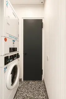 a view of a hallway with washer and dryer