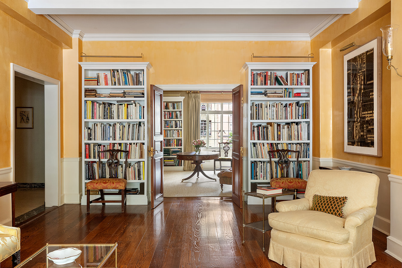 116 East 68th Street, Unit 2D Manhattan, NY 10065 - Photo 3 of 12 a living room with furniture and a book shelf