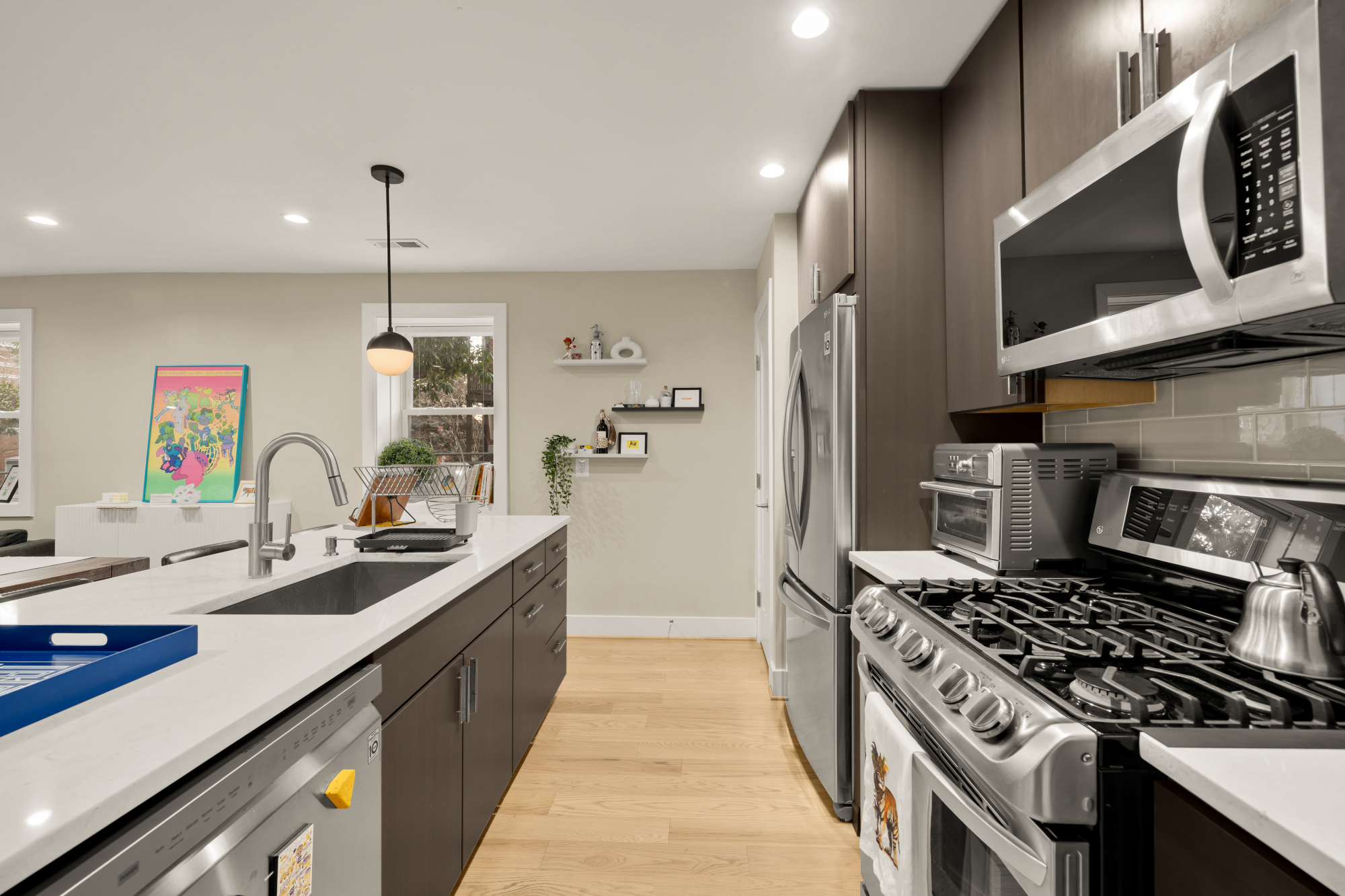 14 T Street Northeast, Unit 1 Washington, DC 20002 - Photo 21 of 39 a kitchen with stainless steel appliances granite countertop a sink a stove and a wooden floor