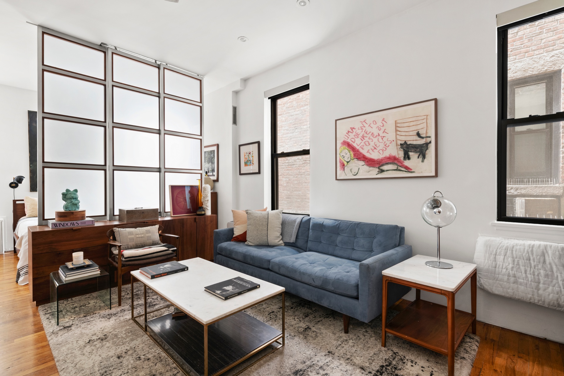 360 West 21st Street, Unit 2L Manhattan, NY 10011 - Photo 2 of 11 a living room with furniture and a window