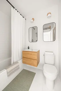 a bathroom with a toilet a sink and bathtub
