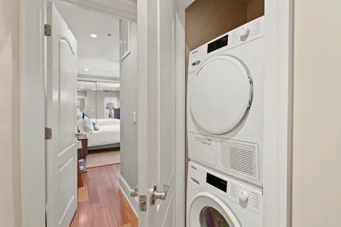 a view of a bedroom with washer and dryer