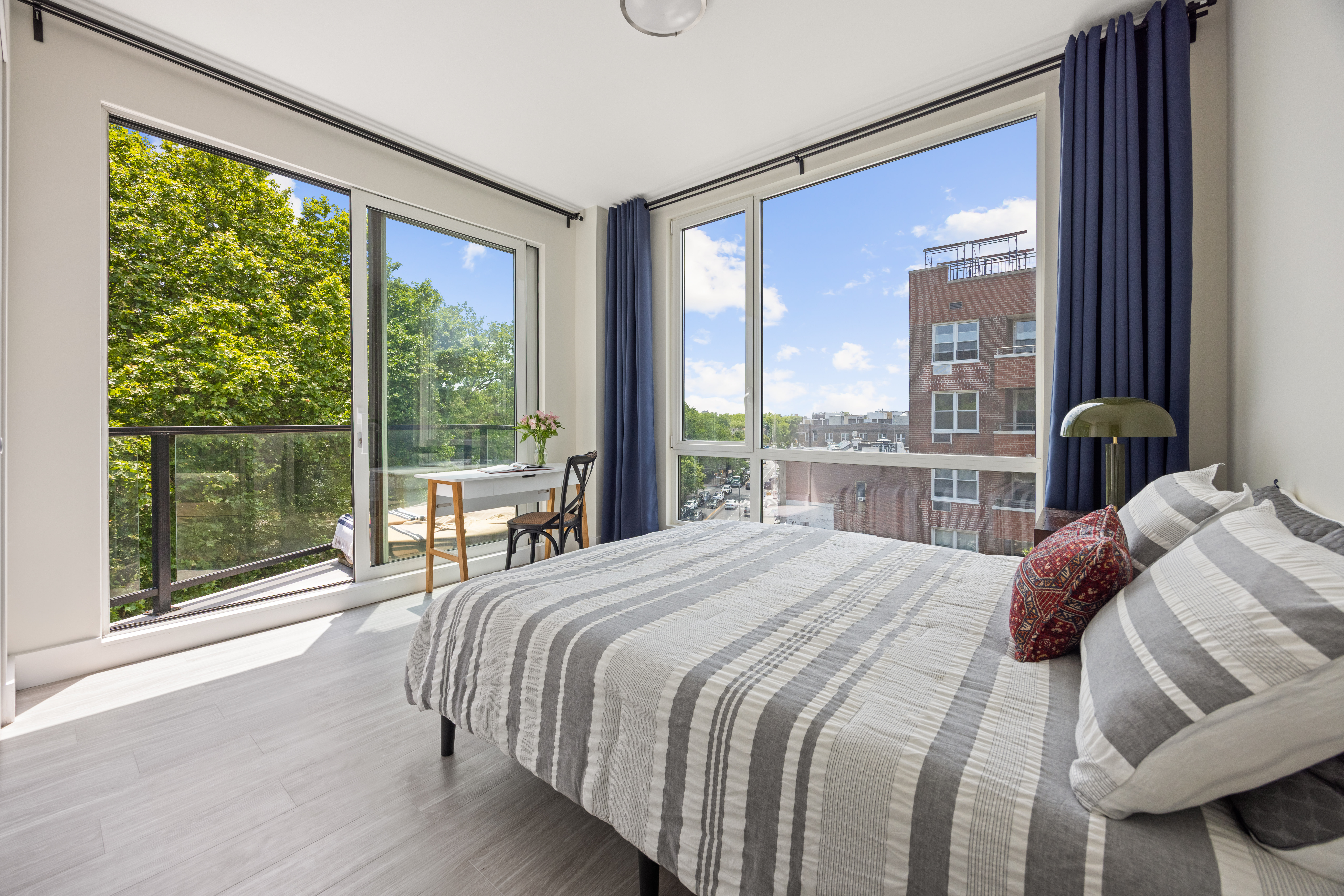 631 East 18th Street, Unit 5C Brooklyn, NY 11226 - Photo 6 of 8 a bedroom with a bed and a large window