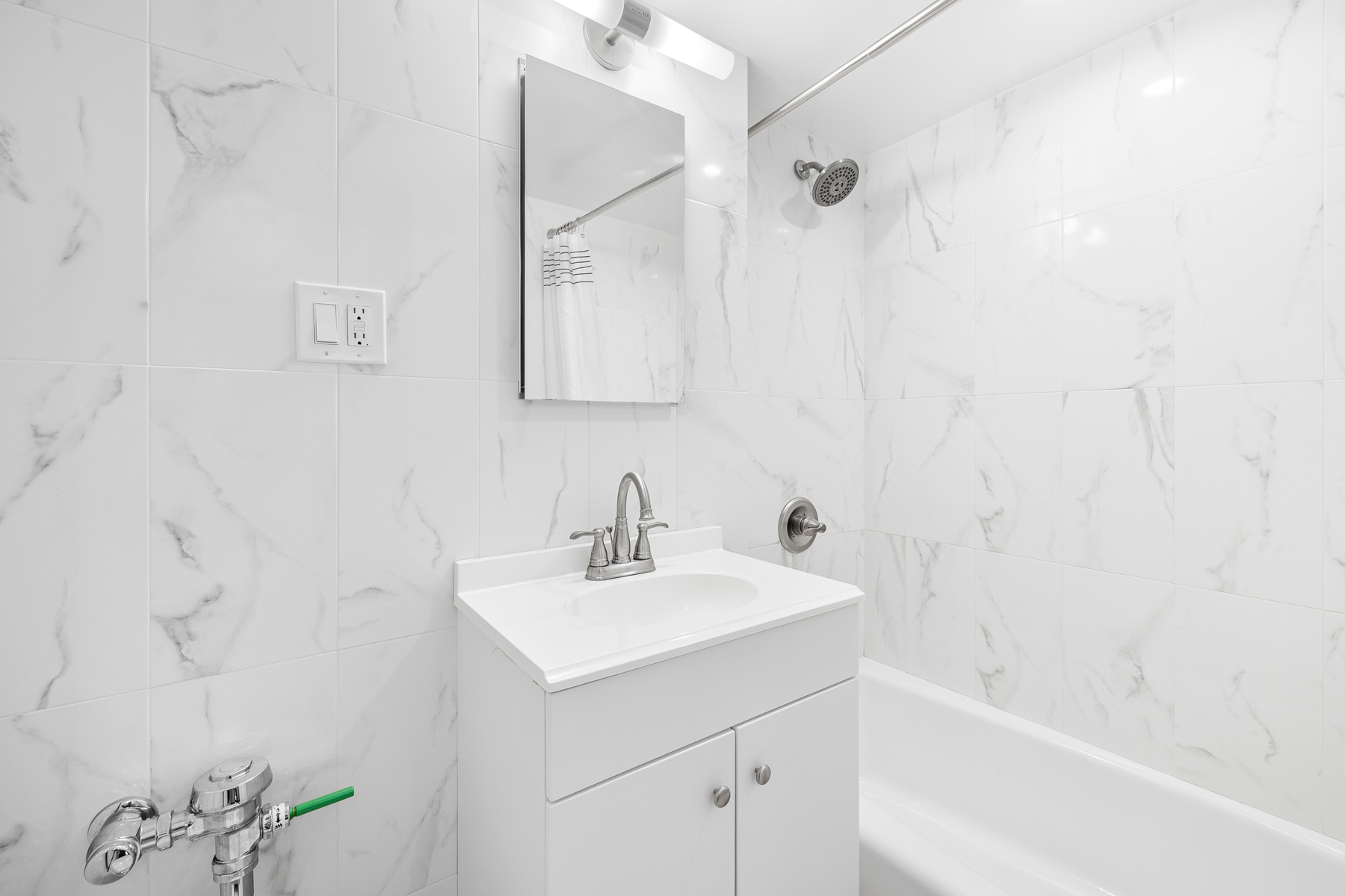 35-11 85th Street, Unit 4F Queens, NY 11372 - Photo 9 of 10 a bathroom with a sink a toilet and shower