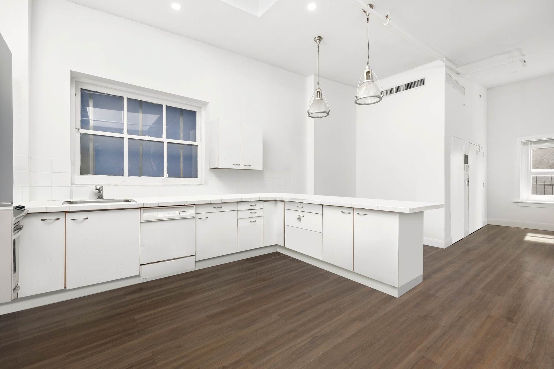 99 Spring Street, Unit PH6 Manhattan, NY 10012 - Photo 6 of 23 a view of an empty room with wooden floor and a window