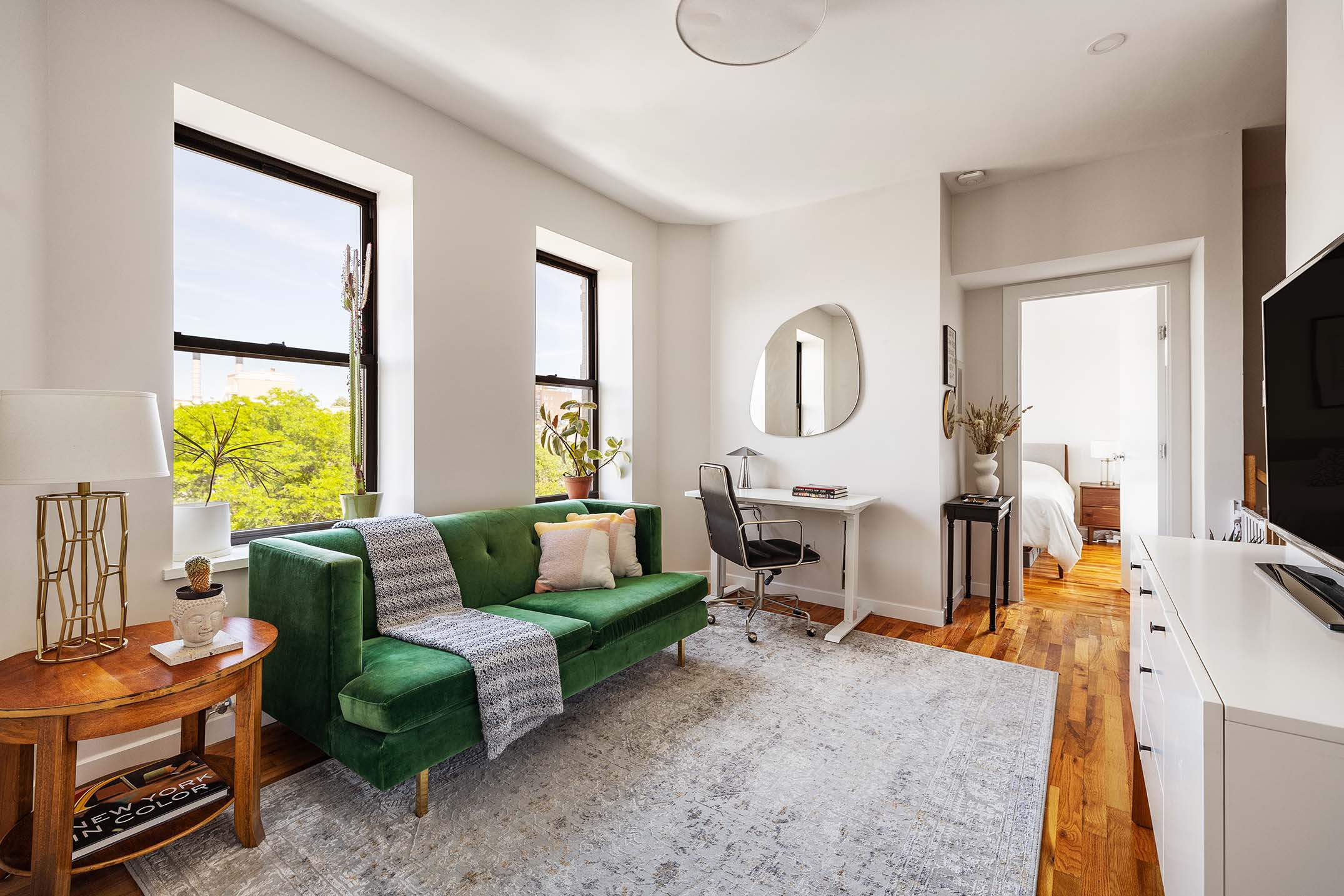 702 East 5th Street, Unit 5E Manhattan, NY 10009 - Photo 5 of 14 a living room with furniture a fireplace and a flat screen tv