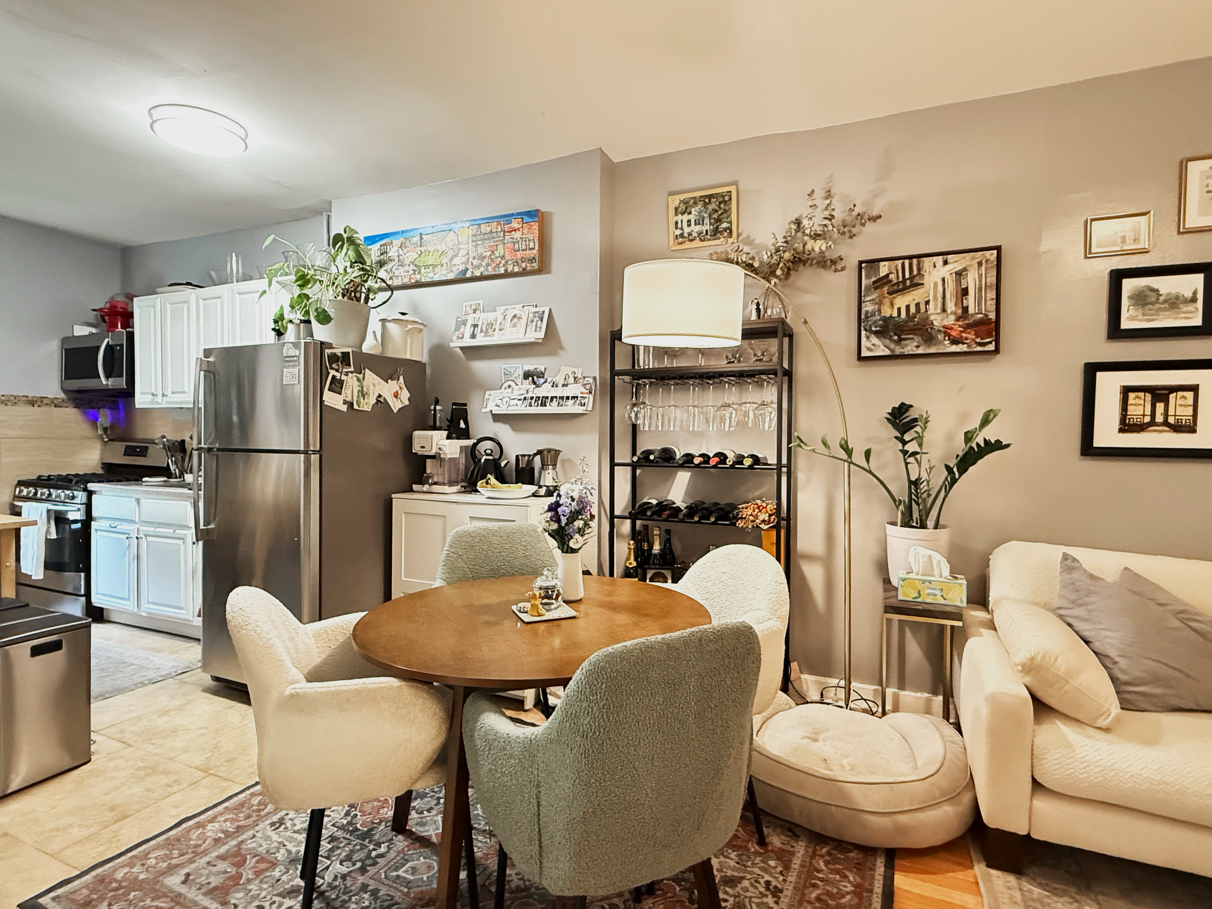 a living room with furniture a refrigerator and kitchen view