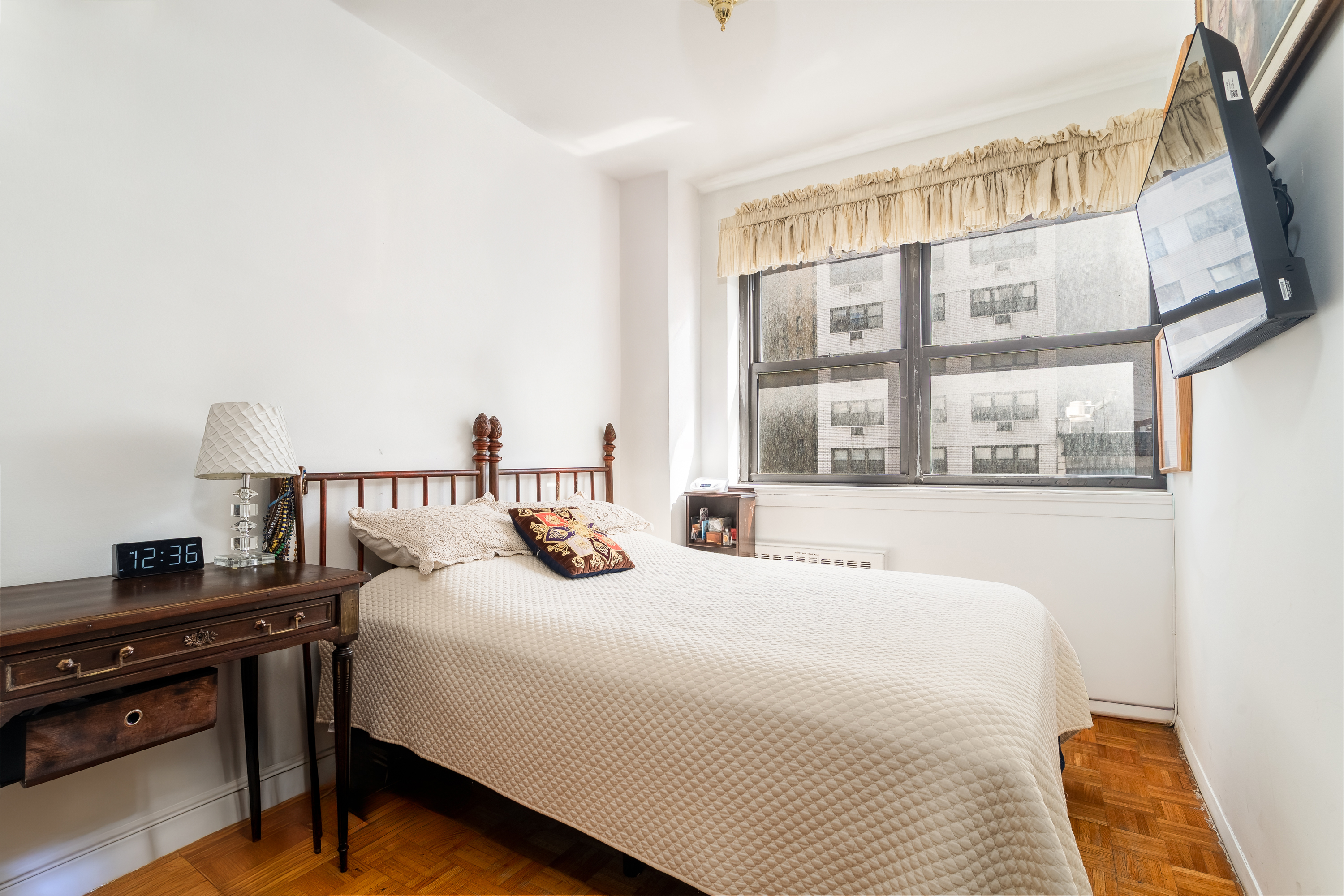 357 East 57th Street, Unit 5C Manhattan, NY 10022 - Photo 6 of 13 a bedroom with a bed and a large window