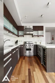 a kitchen with stainless steel appliances a stove sink and cabinets