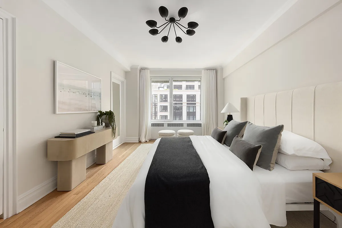 180 East 79th Street, Unit 14B Manhattan, NY 10075 - Photo 13 of 18 a bedroom with a large bed and a window