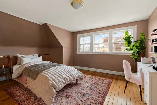a bedroom with a bed and a chair