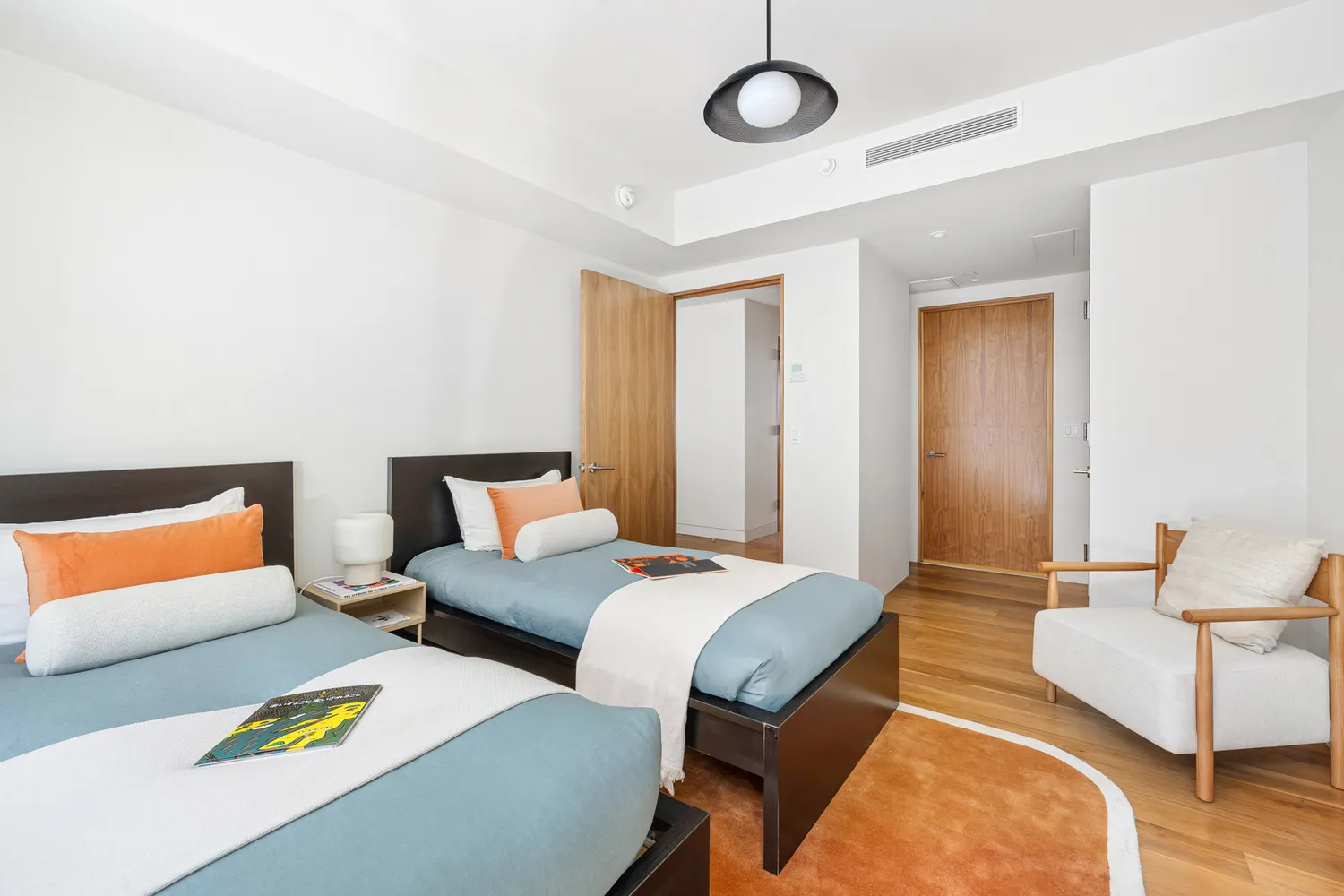 a bedroom with two beds and painted walls