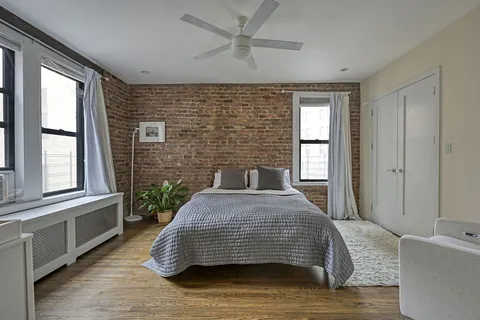 a bedroom with a bed and window