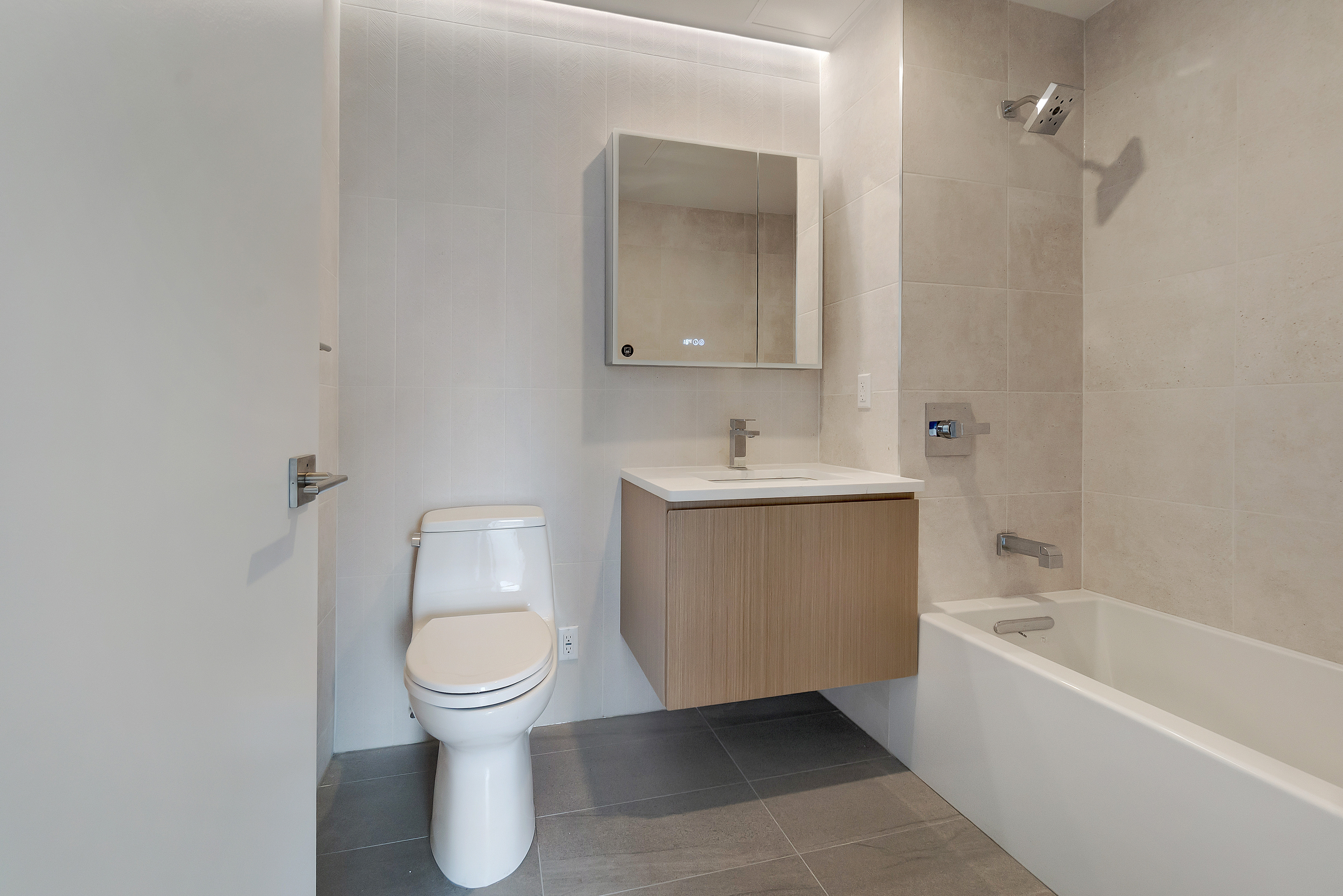 2286 Cropsey Avenue, Unit 6G Brooklyn, NY 11214 - Photo 8 of 22 a bathroom with a toilet sink and mirror