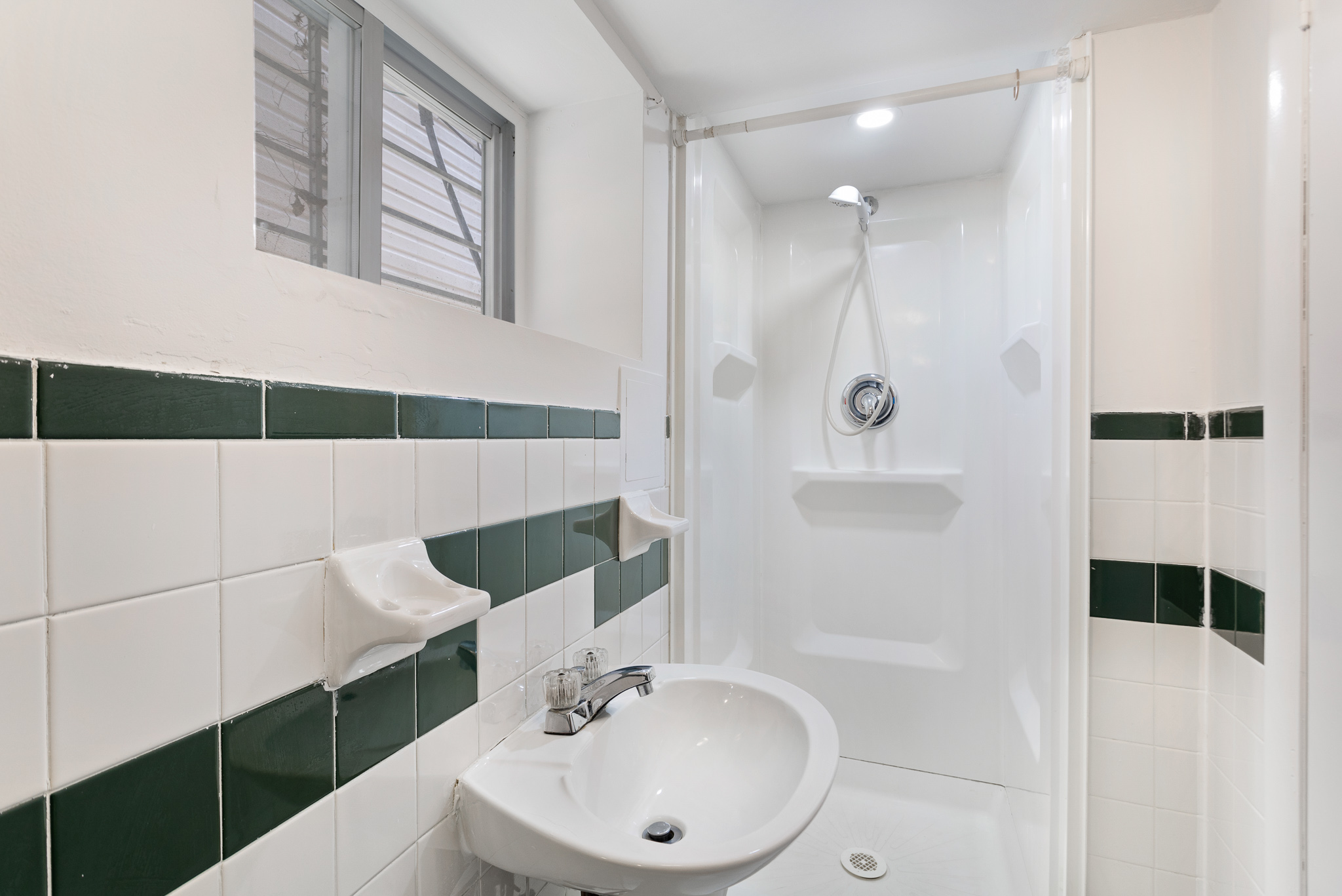 91-22 92nd Street Queens, NY 11421 - Photo 19 of 27 a bathroom with a sink a toilet and shower
