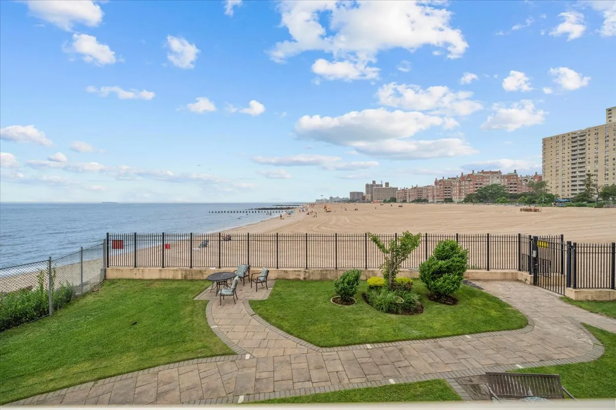 a view of a garden with a building in the background