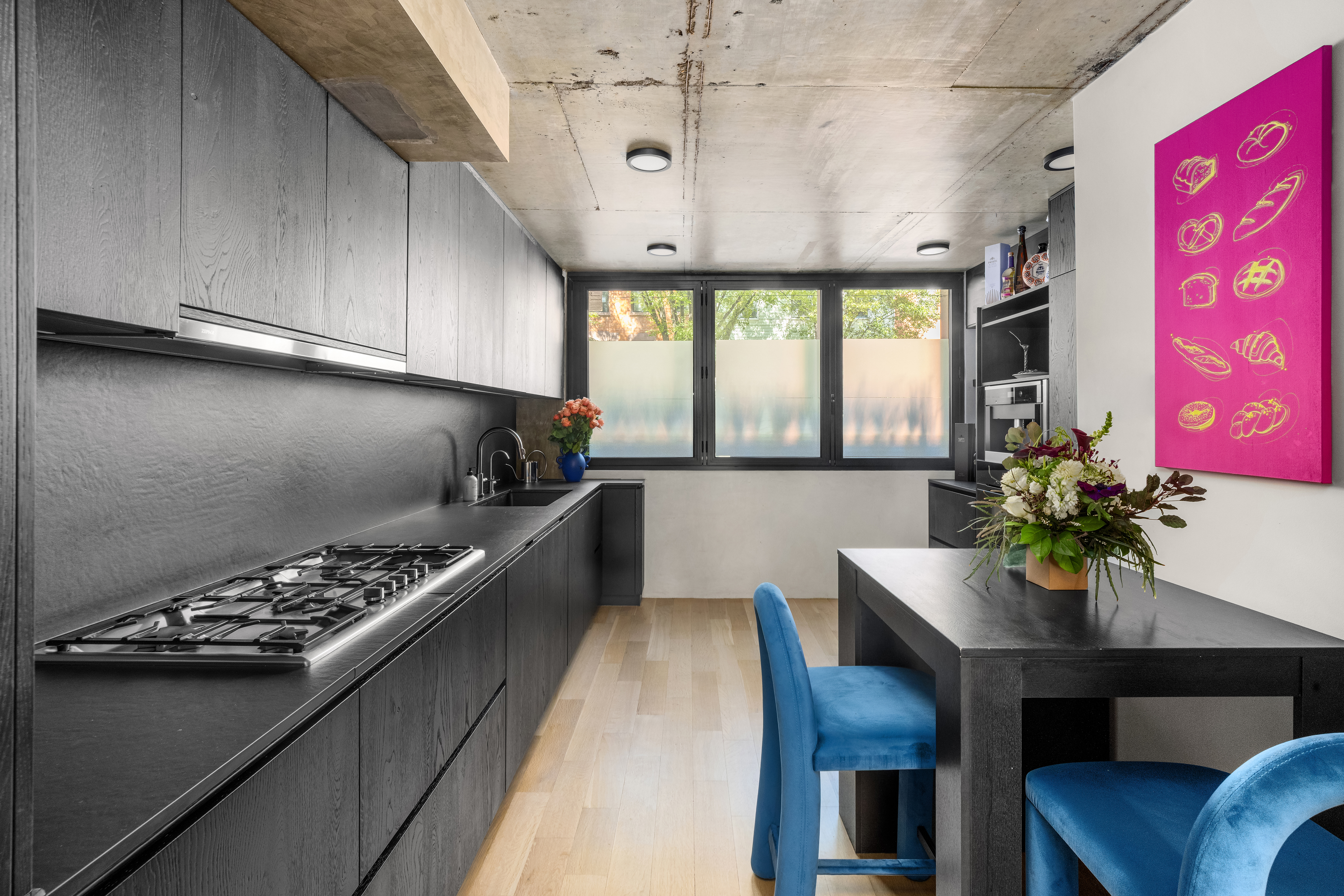 126 South 2nd Street, Unit GARDEN Brooklyn, NY 11249 - Photo 9 of 30 a kitchen with stainless steel appliances kitchen island granite countertop a stove a sink dishwasher and cabinets with wooden floor
