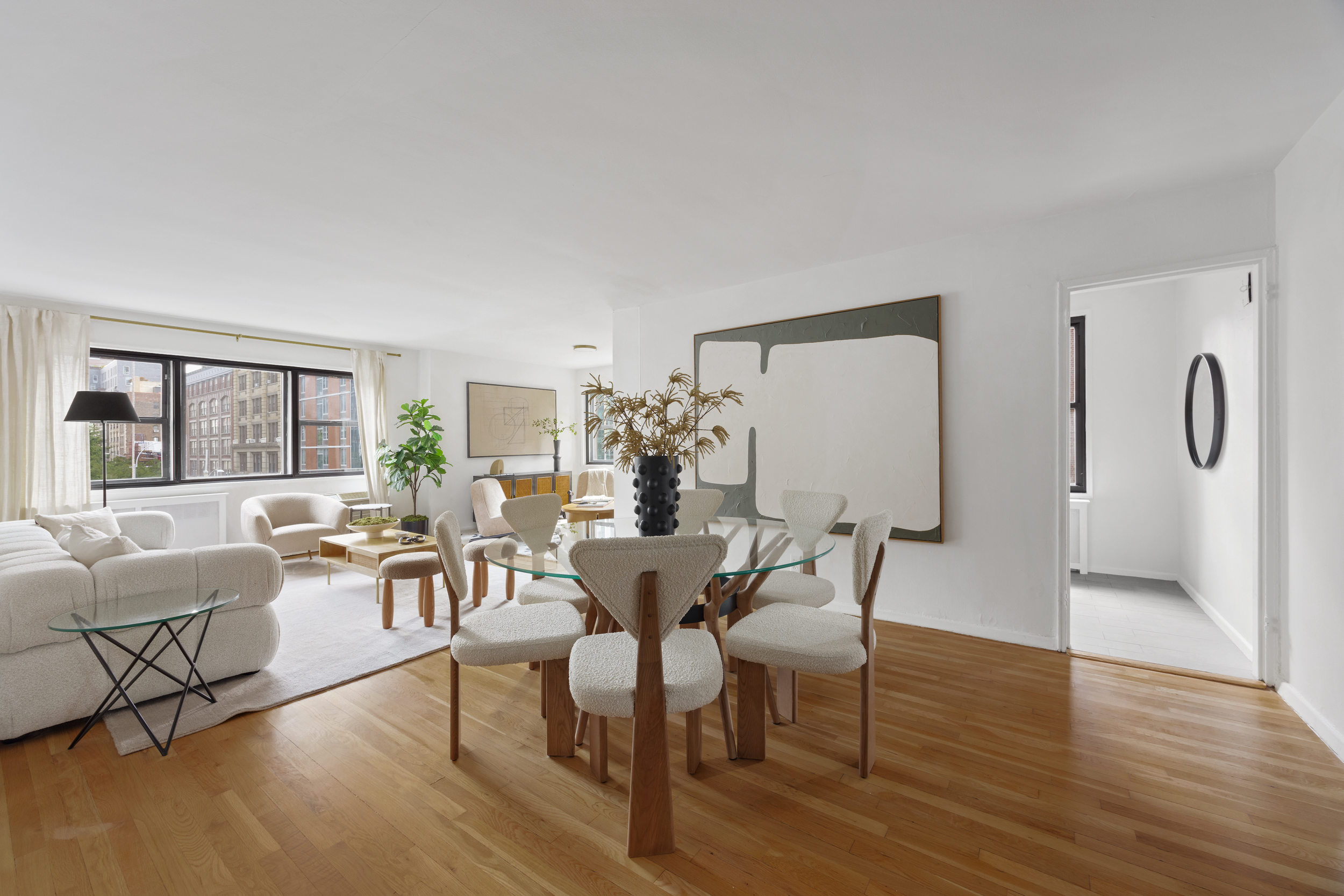 140 7th Avenue, Unit 4L Manhattan, NY 10011 - Photo 1 of 14 a view of a dining room with furniture and wooden floor