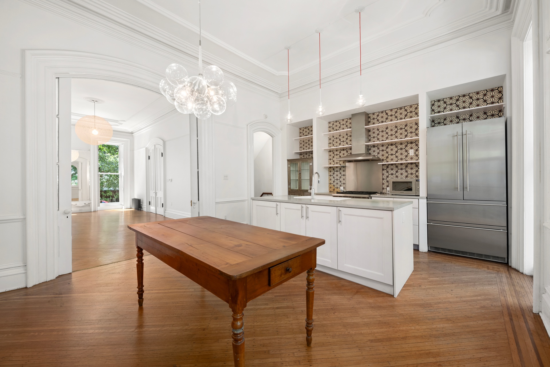 73 St James Place, Unit 2 Brooklyn, NY 11238 - Photo 3 of 15 a kitchen with a table and refrigerator