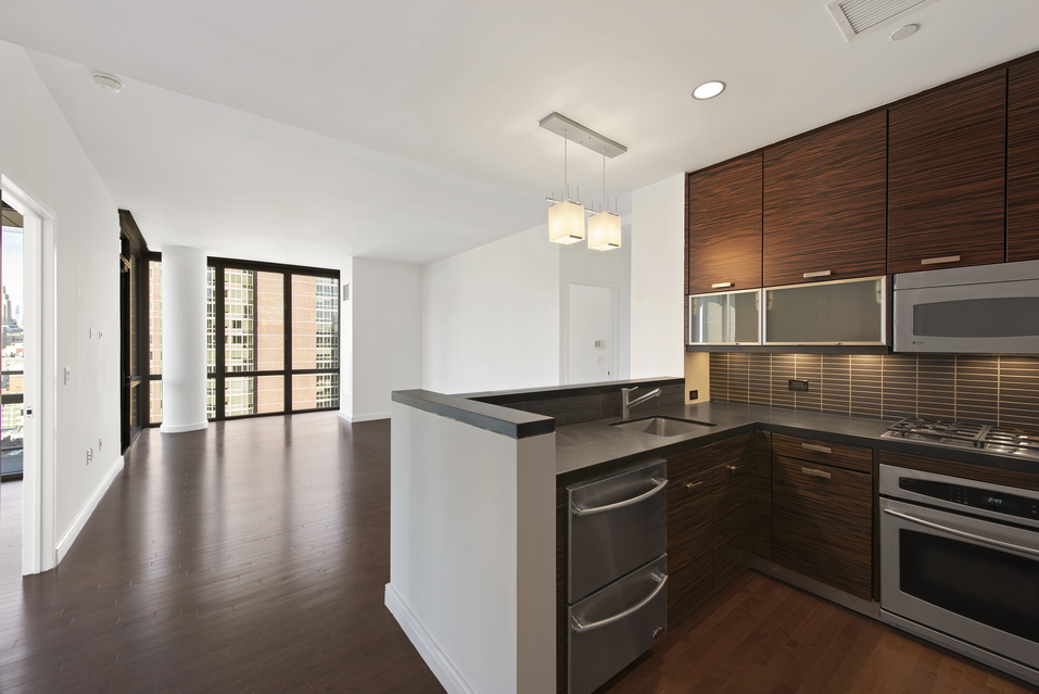 101 West 24th Street, Unit 26A Manhattan, NY 10011 - Photo 2 of 21 a kitchen with granite countertop a stove and cabinets